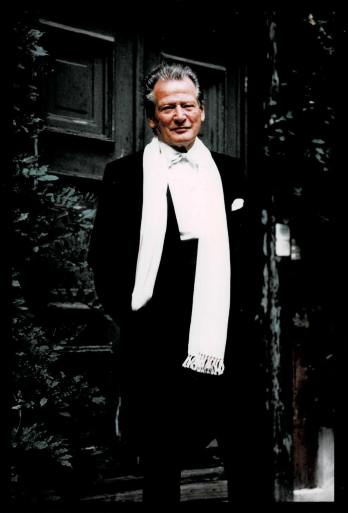 A colour photo of Neville Marriner in his prime, posed against a street doorway in Berlin, in full evening clothes and white silk scarf – the very image of a successful conductor.