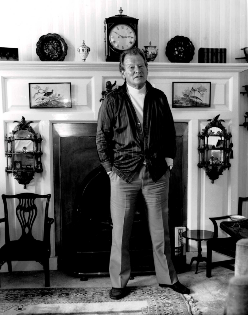 In black-and-white, Sir Neville Marriner stands in front of the fireplace in the room at Cornwall Gardens where the fledgling ASMF crammed itself in and played till all hours, in the early days.
